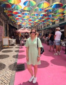 Mel Standing under colourful umbrella's